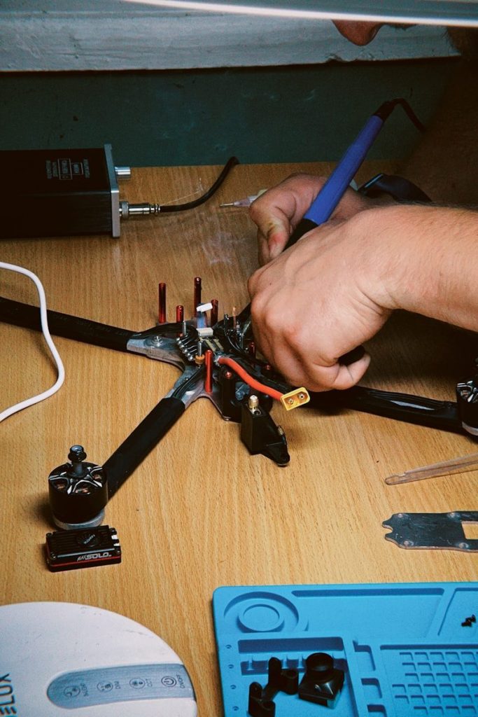 A person working on a piece of equipment on a table